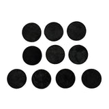 Set of black round felt pads on a white background