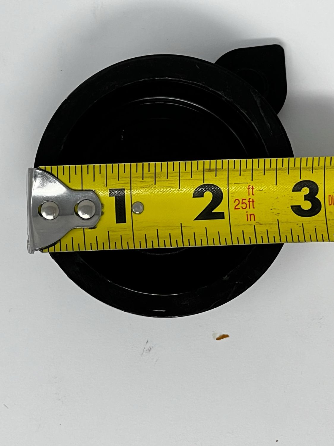 High Country Plastics black replacement cap ZC-100638 shown with a tape measure for sizing