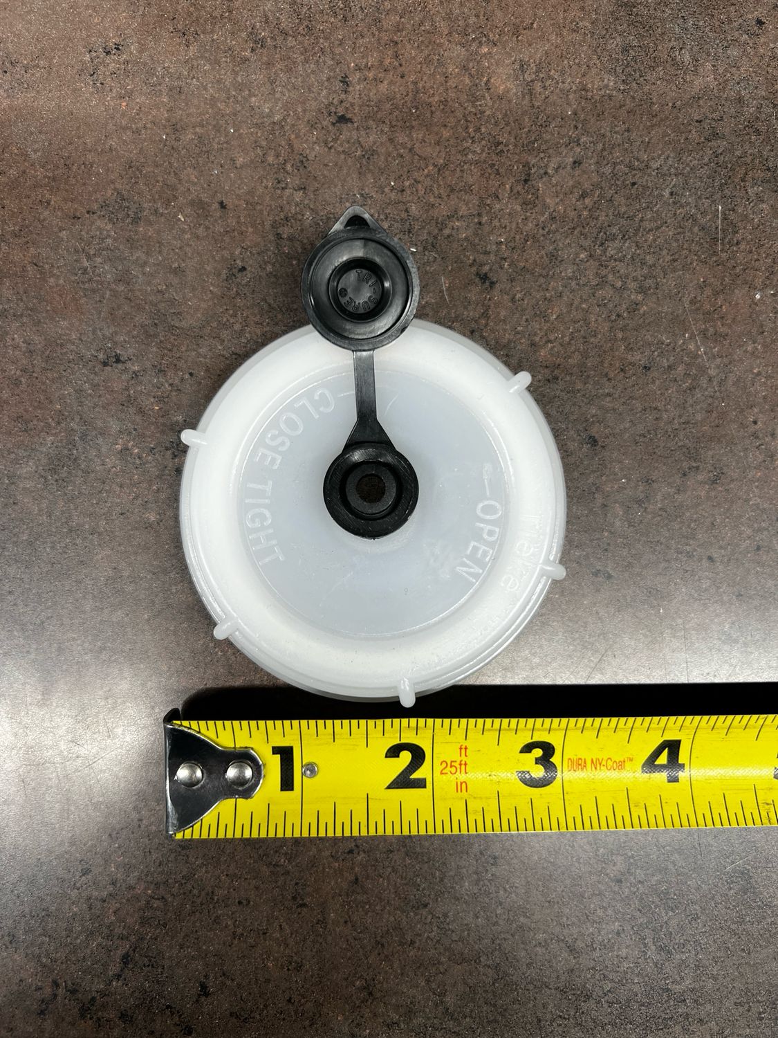 High Country Plastics white replacement cap ZC-100638-N shown with a tape measure for sizing