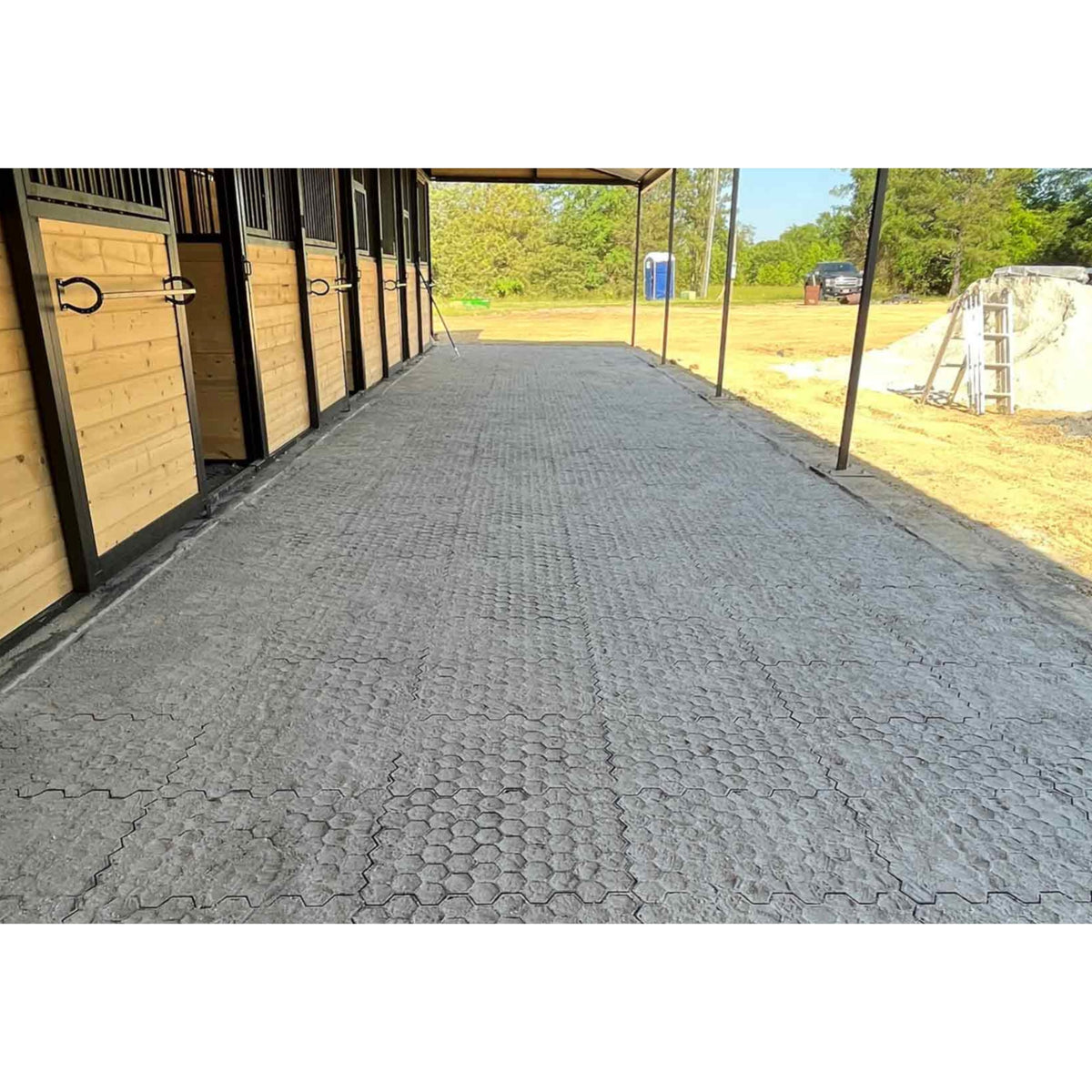 Hahn Paddock Slabs forming a barn aisle along a row of stall fronts